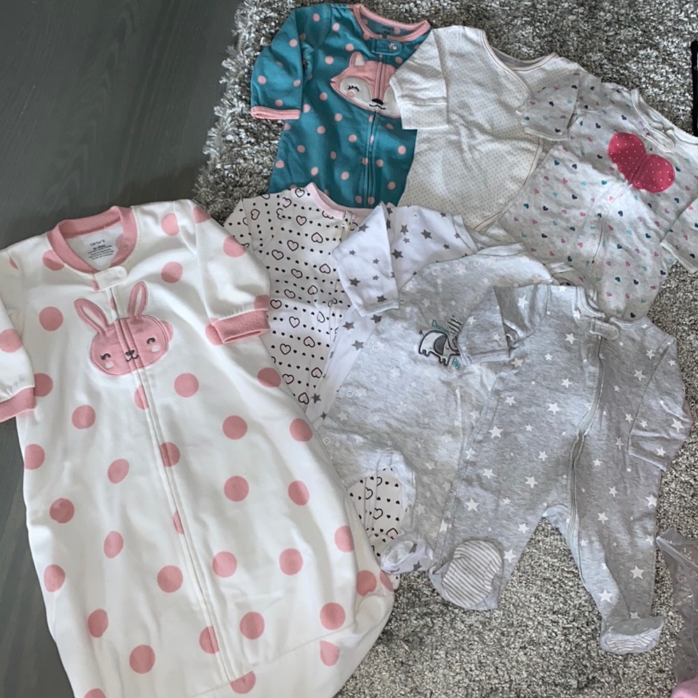 Lot of footsie pajamas and a sleep sack